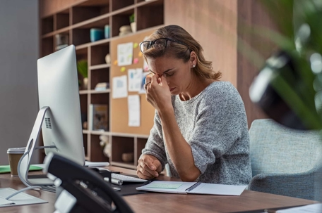 a woman upset at her desk